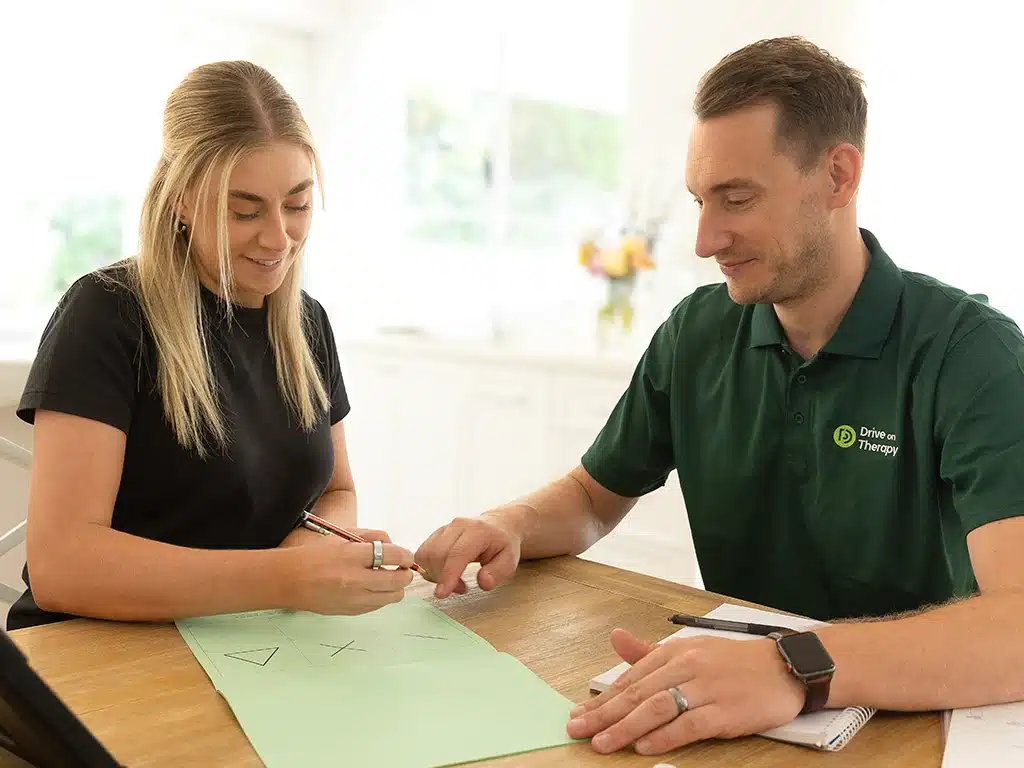 Client and therapist working on a cognitive worksheet as part of a driving capacity assessment.