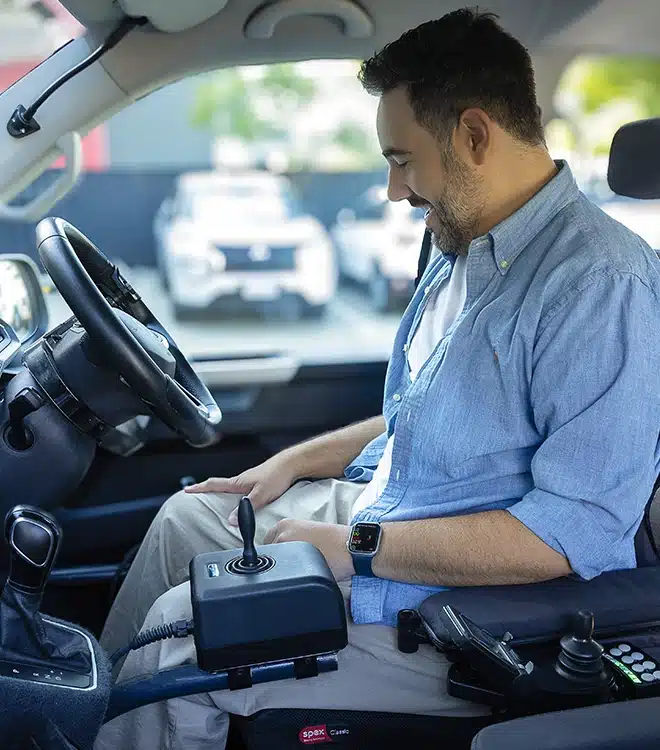 Client using high-level joystick control system during specialist driving assessment for complex needs.